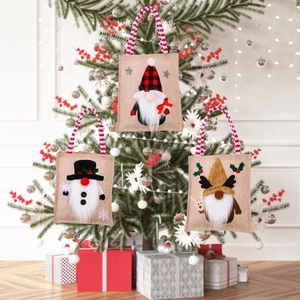 Three festive Christmas burlap gift bags featuring Santa, snowman, and reindeer designs