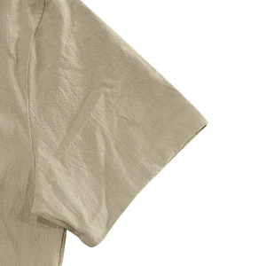 Detailed macro view showing the natural linen fabric texture and stitching of the shirt sleeve