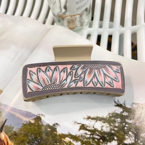 Floral print beige square claw clip for women on magazine background for western cowboy style