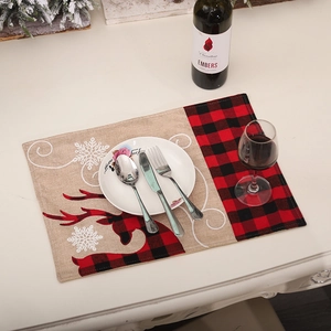 Christmas place mat with embroidered reindeer and snowflake on red and black buffalo plaid