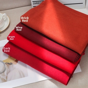 Detailed texture view of soft solid color scarves in four shades of red fabric