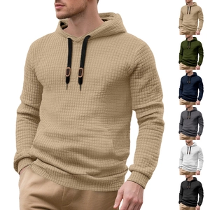 Detailed close-up showing textured waffle pattern fabric and hoodie drawstring quality