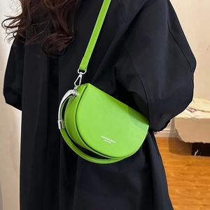 Fluorescent green leather half-moon saddle bag with silver metal handle and shoulder strap