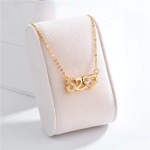 Macro shot of gold 520 heart pendant necklace with shimmering crystals on velvet