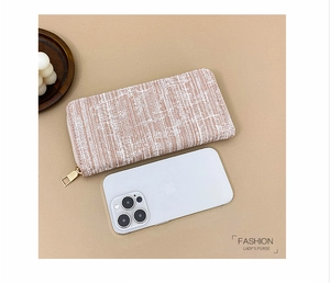Beige striped long wallet for women shown next to a smartphone for size reference