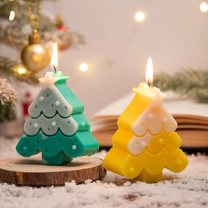 Festive Christmas tree candles in green and yellow colors for holiday atmosphere