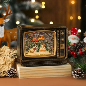 Vintage bronze TV Christmas snow globe with Santa sleigh scene and warm bokeh lights