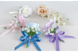 Six assorted colors of artificial rose boutonnieres with pearls and ribbons for weddings