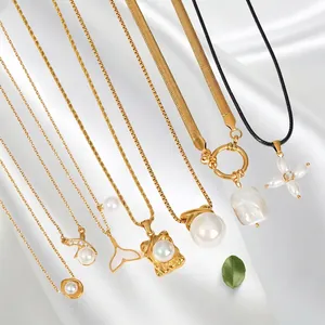 Elegant gold stainless steel necklaces with various pearl pendants on white silk