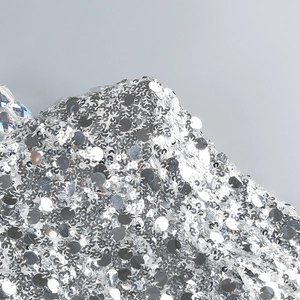 Close-up of high-density silver sequins sewn on a luxury evening party dress