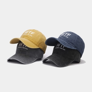 Detailed view of washed vintage baseball caps in ginger, grey, blue, and black colors
