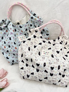 Quilted cartoon canvas tote bags in light blue and cream with colorful rope handles