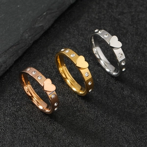 Detailed trio of polished heart rings in gold, rose gold, and silver with inset rhinestones
