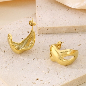 Detail of 18k gold-plated infinity twist earrings on stone and silk background