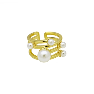 Macro shot of multi-layer gold plated ring featuring white pearls and zircon details