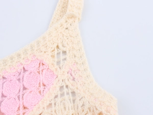 Detail shot of the beige and pink floral crochet knit strap with intricate hollowed patterns
