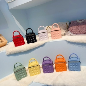 Detailed grid of mini studded bucket bags in nine bright colors with twisted rope handles
