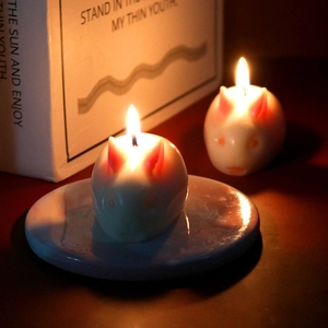 Pair of lit rabbit-shaped craft candles in white and pink for home atmosphere decor