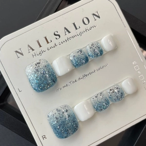 Sky blue glitter gradient and white press-on toenails set in professional packaging