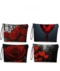 Detail showing various dark rose and red heart prints on cosmetic bags with wristlet straps