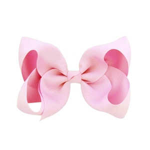 Detail of 4-inch pink handmade grosgrain ribbon hair bow clip for girls and toddlers