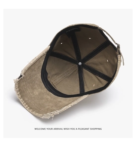 Detail view of khaki washed baseball cap interior with sweatband and bronze metal buckle