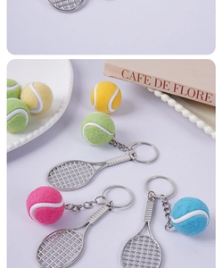 Detailed view of mini tennis racket and flocked ball keychains in multiple vibrant colors