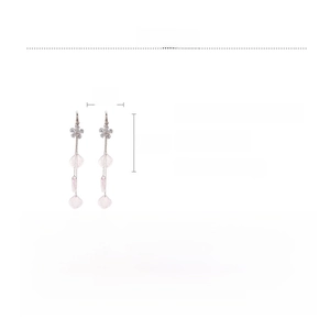 Detail view of long tassel earrings with resin flower petals and sparkling zircon studs