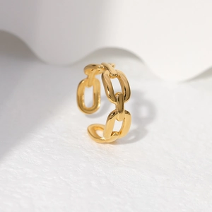Detail of a chunky gold chain-link open ring showing its bold texture and metallic shine