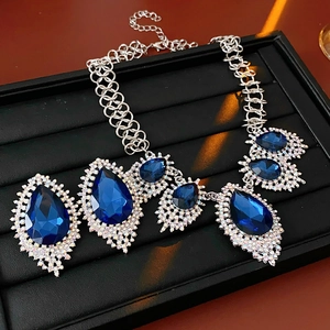 Macro detail of teardrop blue gemstone necklace with pave crystals in a gift box