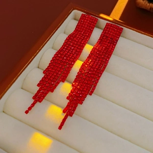 Detail of red tassel earrings with sparkling crystals in a velvet jewelry gift box