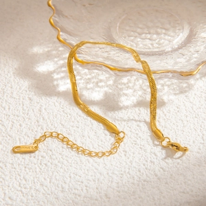Detail of 18k gold plated stainless steel snake chain with starburst engraving