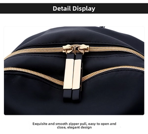 Detail of smooth golden metal dual zippers on black Oxford fabric backpack