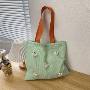 Detail of green striped seersucker tote bag with cute 3D white duck ornaments