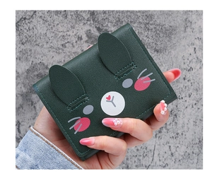 Detailed view of small green faux leather bifold wallet with cute rabbit ears design