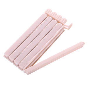 Set of 6 pink plastic food bag sealing clips for snack preservation on white background