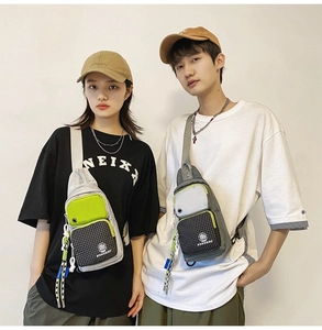 Waterproof street style chest bag in gray and neon green shown on a fashion model