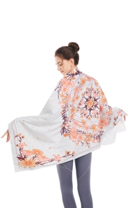 Microfiber beach towel with orange mandala pattern on light cream background