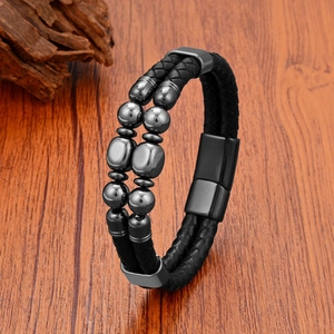 Detail of men's double-row braided leather bracelet with tiger eye beads and magnetic clasp