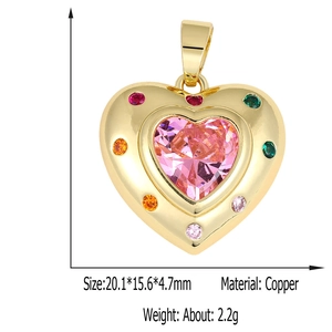 Detail of pink heart crystal pendant in gold copper with multicolor gemstone border