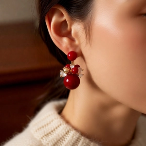 Macro shot of 18K gold plated vintage red cluster earrings with crystal beads on a model