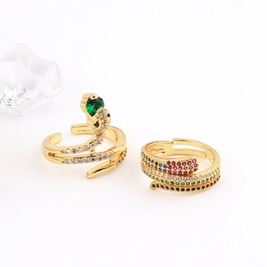 Close-up of gold snake rings featuring colorful zircon stones and adjustable open band design