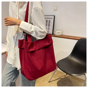Detail of the soft dark red nylon fabric and spacious interior of the tote bag