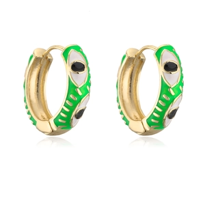 Detailed view of bohemian 18K gold-plated eye earrings with green enamel inlay