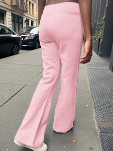 Rear view of pink flared yoga pants showing soft fabric and comfortable fit on city street