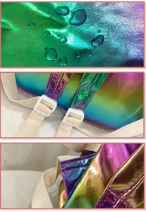 Detail view of waterproof laser holographic fabric and reinforced stitching on backpack