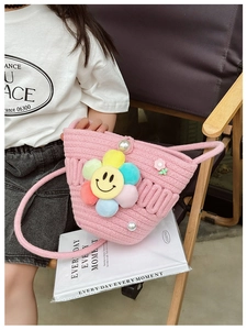 Pink woven kids handbag with colorful plush smiley flowers and elegant pearl accents