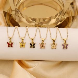 Detailed display of six gold butterfly necklaces with multicolor zircon on white stand