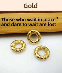 Detailed view of three golden Tibetan silver alloy spacers with traditional cloud pattern