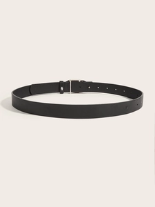 Close-up of black leather belt with silver heart buckle and metal eyelets detail